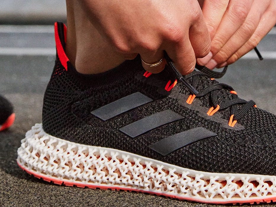 A person lacing an adidas 4DFWD shoe