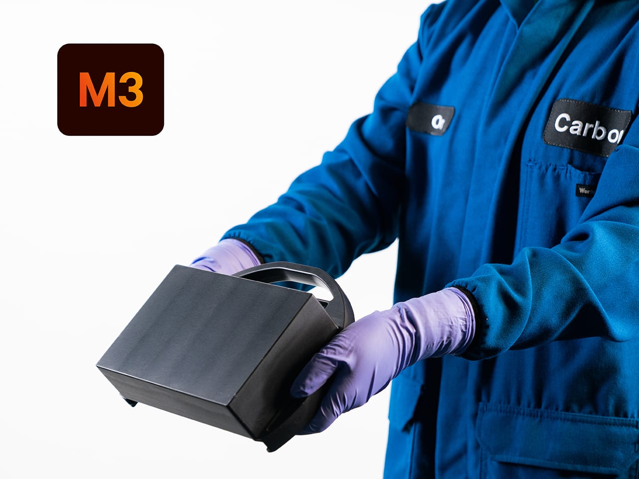 A lab worker holding the M3 printing platform